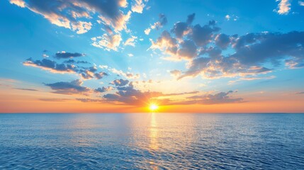 Obraz premium The sun sets over the ocean, foreground dotted with a near boat and a distant one Sky above waters adorned with clouds
