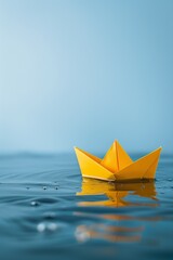 Yellow Origami Paper Boat Floating on Water, Calm Amid Challenges and Adversity