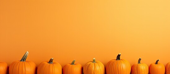 A Halloween themed copy space image displays pumpkins against an orange background