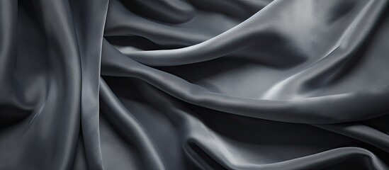 Obraz premium A dark gray soft cloth background resembling the texture of velvet canvas with ample copy space image