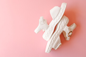 Female summer sandals on a pink background