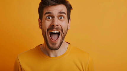 The handsome man seems surprised and excited, his face radiates joy and a smile.