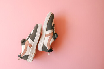 Children's sneakers on a pink background, style and fashion