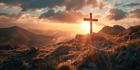 A cross is on a hillside with a beautiful sunset in the background