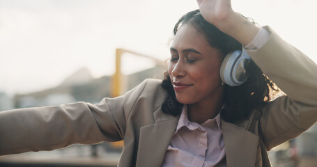 Happy person, headphones and dancing in city with music on app for online streaming in outdoor for celebration. Career woman, technology and cheerful for promotion, achievement or success in England