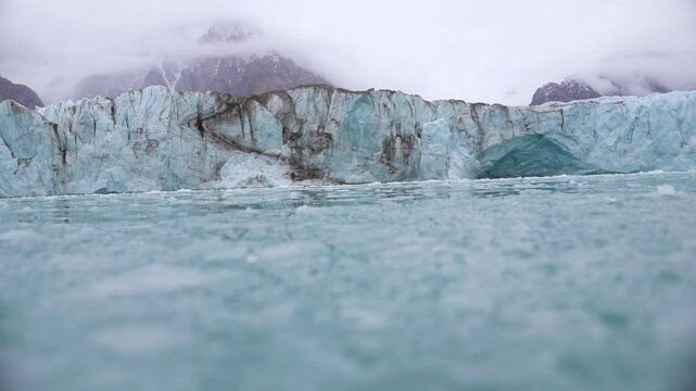 Pieces of Broken Ice Under Glacier, Low Angle View From Moving Boat