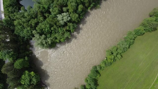 vertical top down view on a river with forests, drone flight