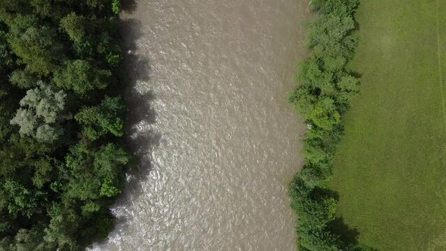 vertical top down view on a river with forests, drone flight
