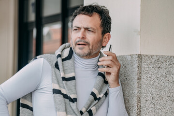 middle aged man talking on the phone on the street