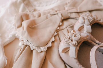 Top view flat lay beige children dress on beige background