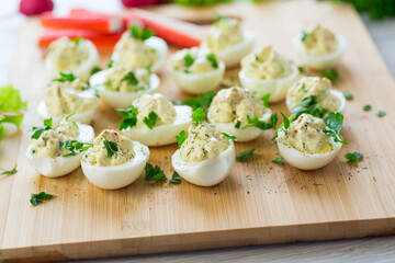 stuffed eggs, deviled eggs on a wooden table