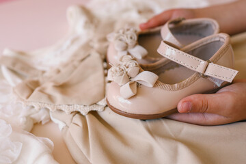 Children's clothes in hands, fashion