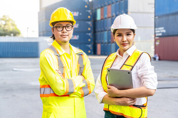 Portrait of group male and female container worker or dock foreman looking at camera and smiling together standing at warehouse logistic in Cargo freight ship for import export, friendship concept