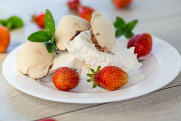 fresh organic cottage cheese with strawberries and ice cream in a plate on a wooden table
