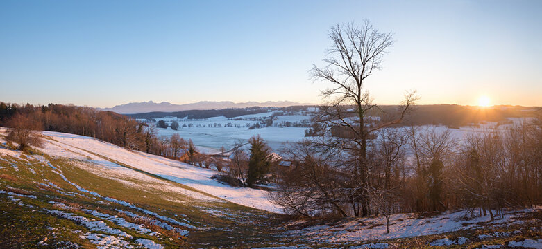 sunset scenery view to bavarian foothills with rest of snow