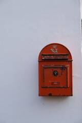 red mailbox on a wall