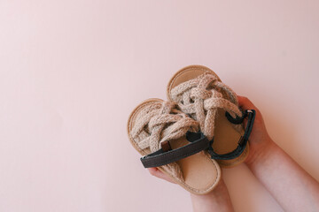 Children's sandals on pastel background, fashion