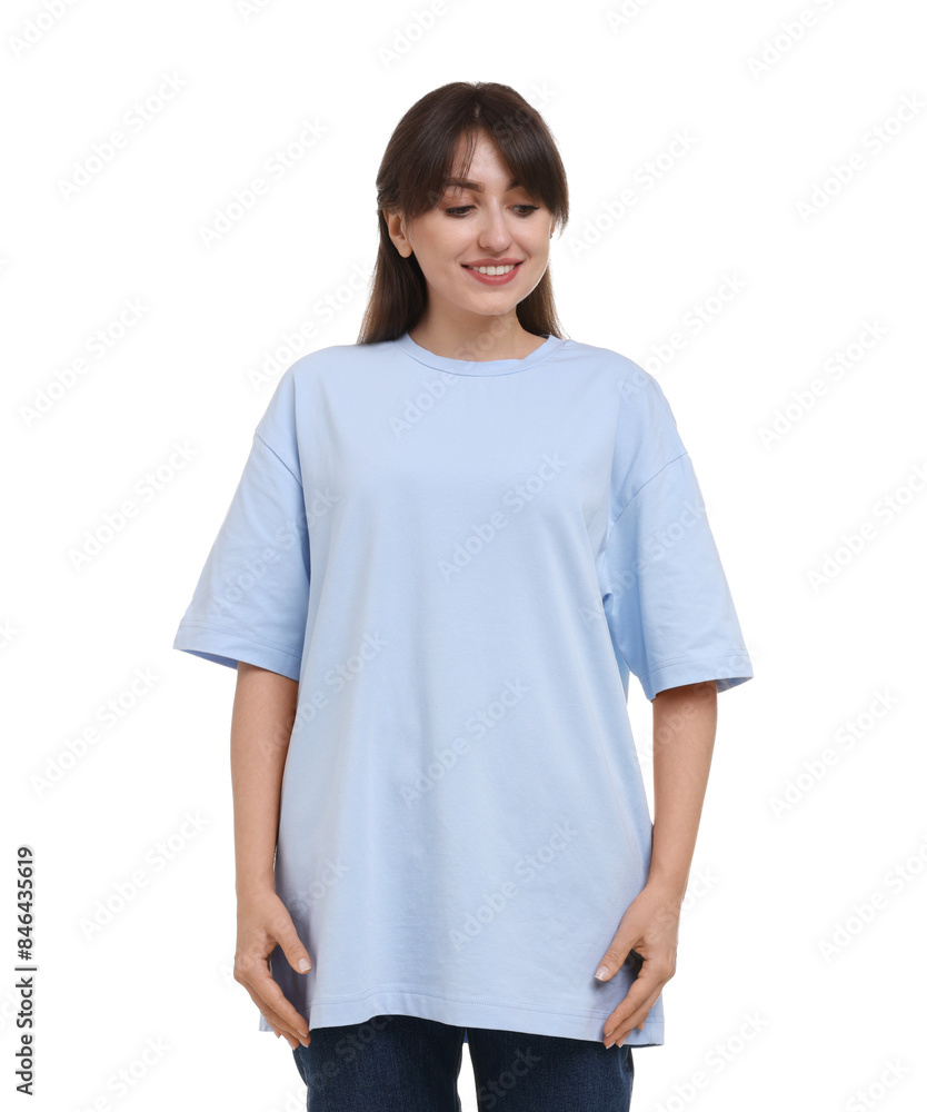 Wall mural Smiling woman in stylish light blue t-shirt on white background