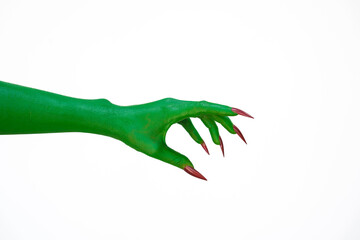 A green monster hand with long nails, isolated against a dark background, evokes horror and fear....