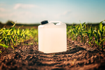 Blank white herbicide canister can in corn seedling field in springtime sunset