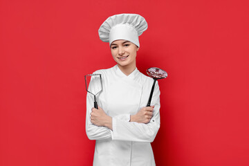 Professional chef with potato pusher and skimmer on red background