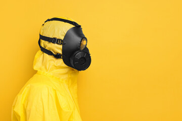 Worker in gas mask on yellow background. Space for text