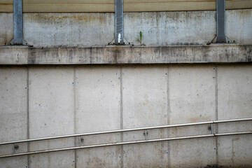 Cement wall constructed with pipes and wooden boards