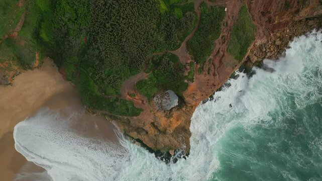 An epic nazare cliff with water surface and greenery