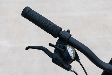 Part of a bicycle steering wheel with gear and brake levers. Close up.
