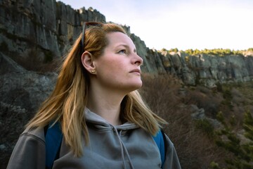 Young woman poses against a mountain backdrop