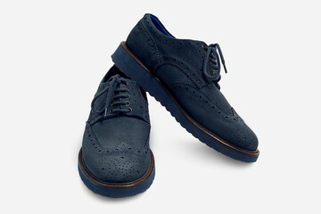 A pair of blue suede shoes, close up isolated on white background.