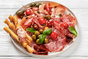 italian antipasto plate of cured meat and veggies