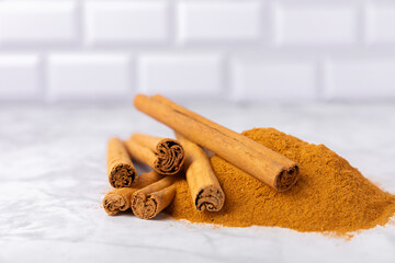 Ceylon cinnamon.Cinnamon sticks on a textured wooden background. Cinnamon roll and powder. Spicy spice for baking, desserts and drinks. Fragrant ground cinnamon. Close-up. Place for text. copy space