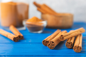 Ceylon cinnamon.Cinnamon sticks on a textured wooden background. Cinnamon roll and powder. Spicy spice for baking, desserts and drinks. Fragrant ground cinnamon. Close-up. Place for text. copy space