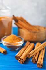 Ceylon cinnamon.Cinnamon sticks on a textured wooden background. Cinnamon roll and powder. Spicy spice for baking, desserts and drinks. Fragrant ground cinnamon. Close-up. Place for text. copy space