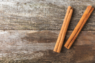 Ceylon cinnamon.Cinnamon sticks on a textured wooden background. Cinnamon roll and powder. Spicy spice for baking, desserts and drinks. Fragrant ground cinnamon. Close-up. Place for text. copy space