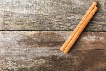 Ceylon cinnamon.Cinnamon sticks on a textured wooden background. Cinnamon roll and powder. Spicy spice for baking, desserts and drinks. Fragrant ground cinnamon. Close-up. Place for text. copy space
