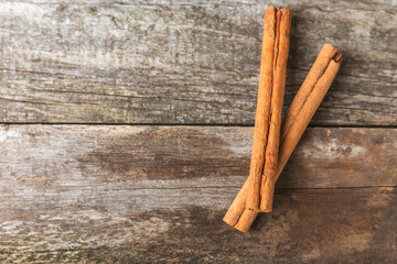 Ceylon cinnamon.Cinnamon sticks on a textured wooden background. Cinnamon roll and powder. Spicy spice for baking, desserts and drinks. Fragrant ground cinnamon. Close-up. Place for text. copy space