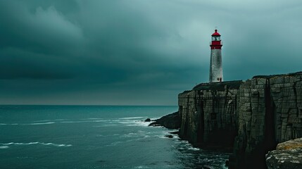 Lonely lighthouse on a cliff edge against a dramatic sky