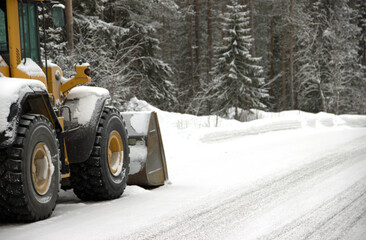 Bulldozer removing snow on a road