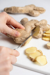 The process of cutting ginger root with a knife