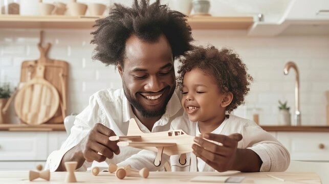 father and child assemble a wooden airplane