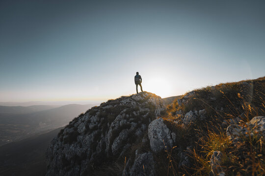 A man who hikers enjoys a break look at the top of the mountain adventure travel. 