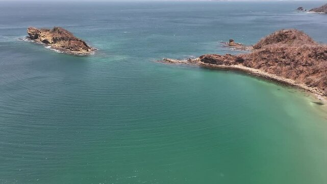 Drone view over the Pacific Ocean showcasing El Jobo beach with cliffs in Guanacaste, Costa Rica