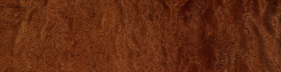 Pommele mahogany veneer with intricate swirling patterns and deep copper tones