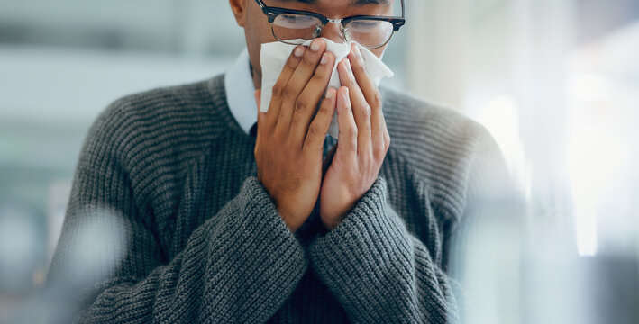Man, sick and sneezing with tissue in hand, healthcare and influenza cold or covid virus for wellness risk in office. Sinus symptoms, allergy problem and seasonal change, hay fever and unwell person