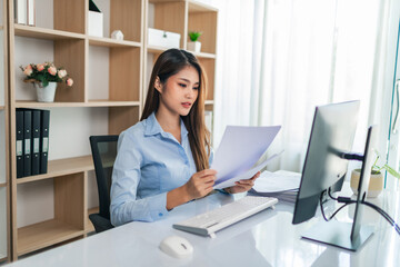 Attractive beautiful Asian business woman working on her project with laptop computer in the office