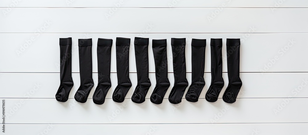 Poster pair blank black small low socks flat lay on white wood board side view mock up for design print pre