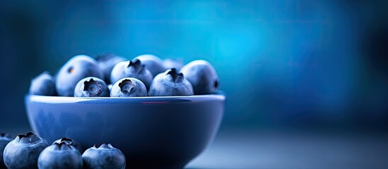 Freshly picked juicy blueberries in the bowl macro close up Blueberries background Concept of healthy nutrition organic food Vegan and vegetarian. copy space available