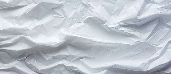Fototapeta premium The white crumpled paper creates an interesting and textured background perfect for a copy space image